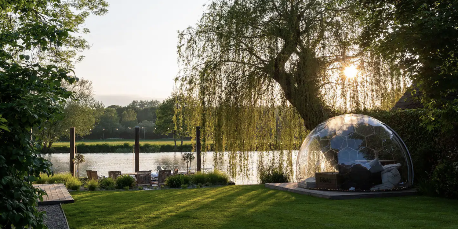 Riversdale Lodge view of willow tree, meditation bubble, and riverside lawn